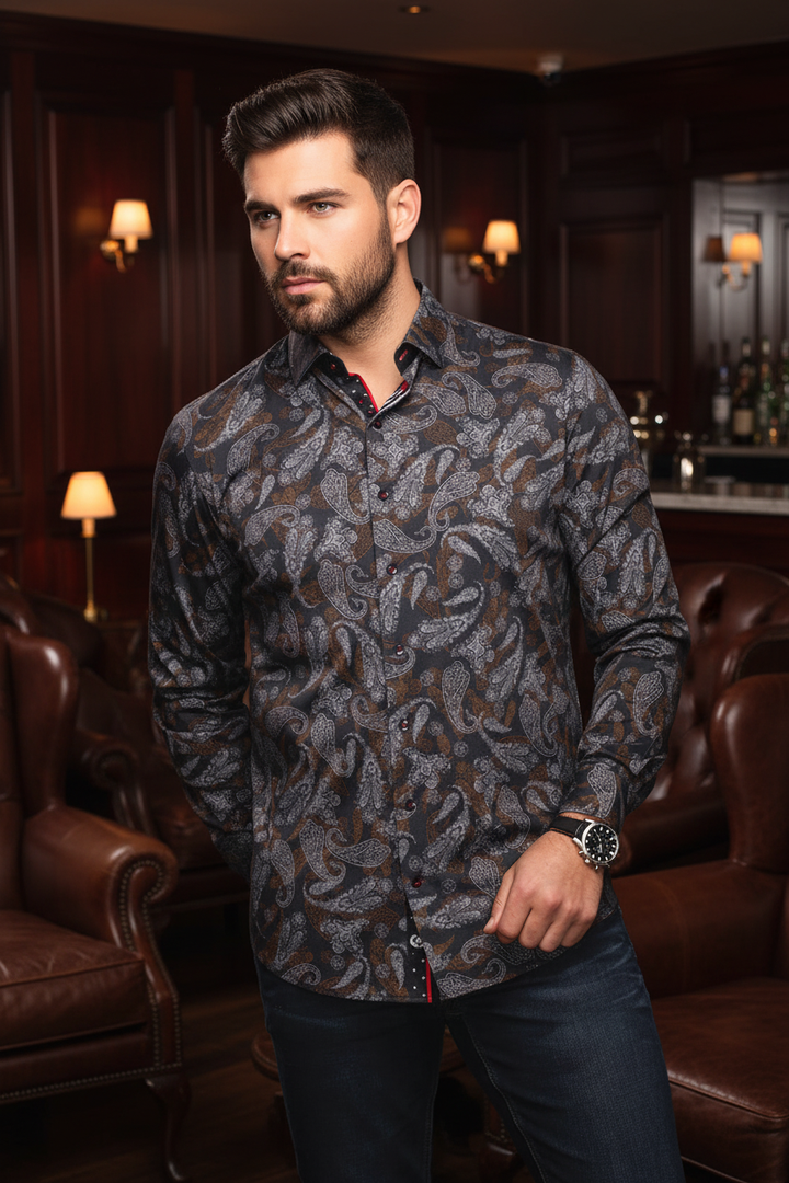 This sophisticated men's button-up features a dark charcoal base with an intricate paisley pattern in muted grey and bronze tones, accented with subtle red stitching. Crafted for a refined look, perfect for evening wear.