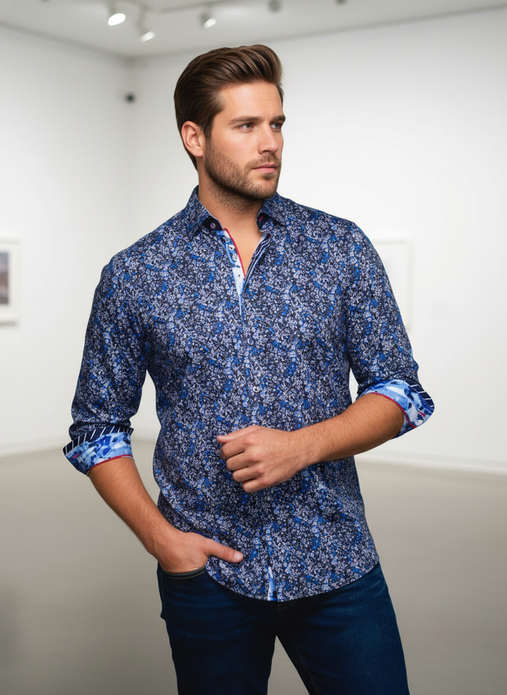 This sophisticated men's button-up shirt features an intricate blue floral pattern on a deep indigo base. Designed with contrasting cuffs and collar accents and subtle red stitching, it offers a refined, modern aesthetic perfect for elevating smart-casual