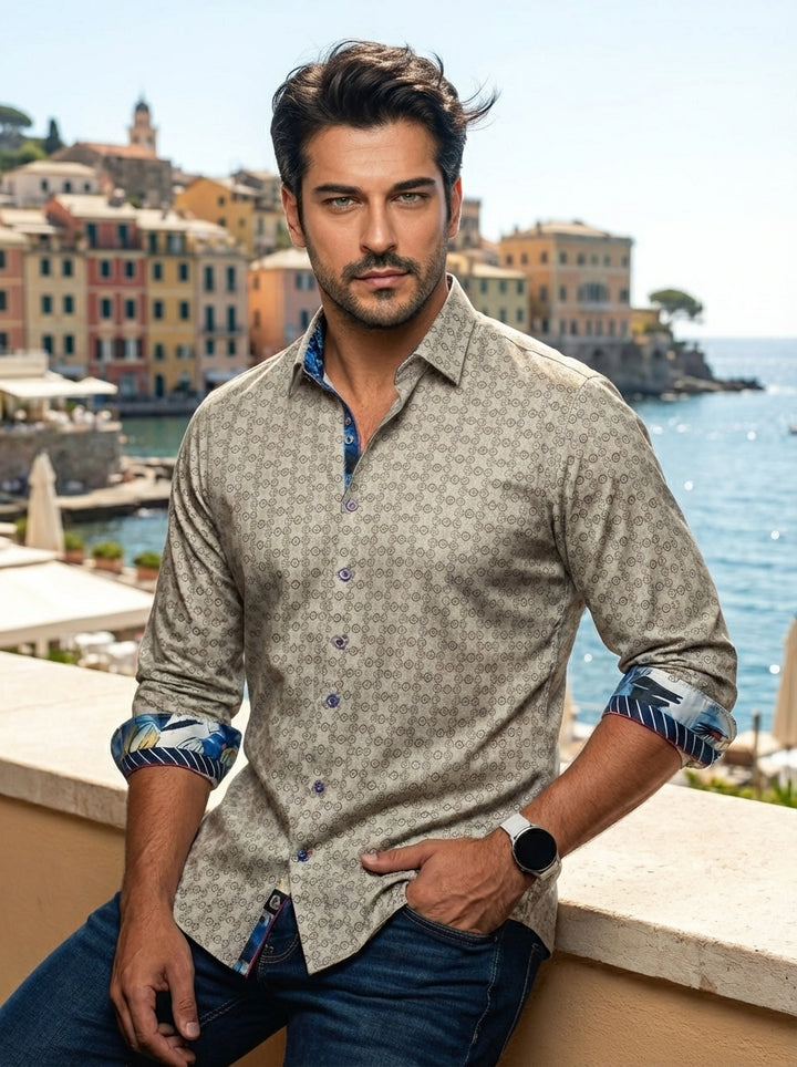 A tailored-fit men's button-down shirt featuring a sophisticated tan geometric medallion pattern. The garment includes contrasting blue floral prints on the inner collar and cuffs, adding a bold contemporary twist to a classic long-sleeve design crafted f