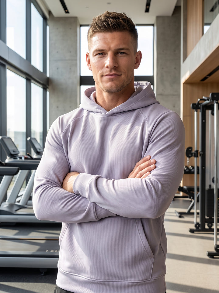 This light lavender performance hoodie features a tailored fit with raglan sleeves and a structured hood. Crafted from a textured moisture-wicking fabric, it provides comfort and versatility for athletic pursuits or casual lounging while maintaining a cle