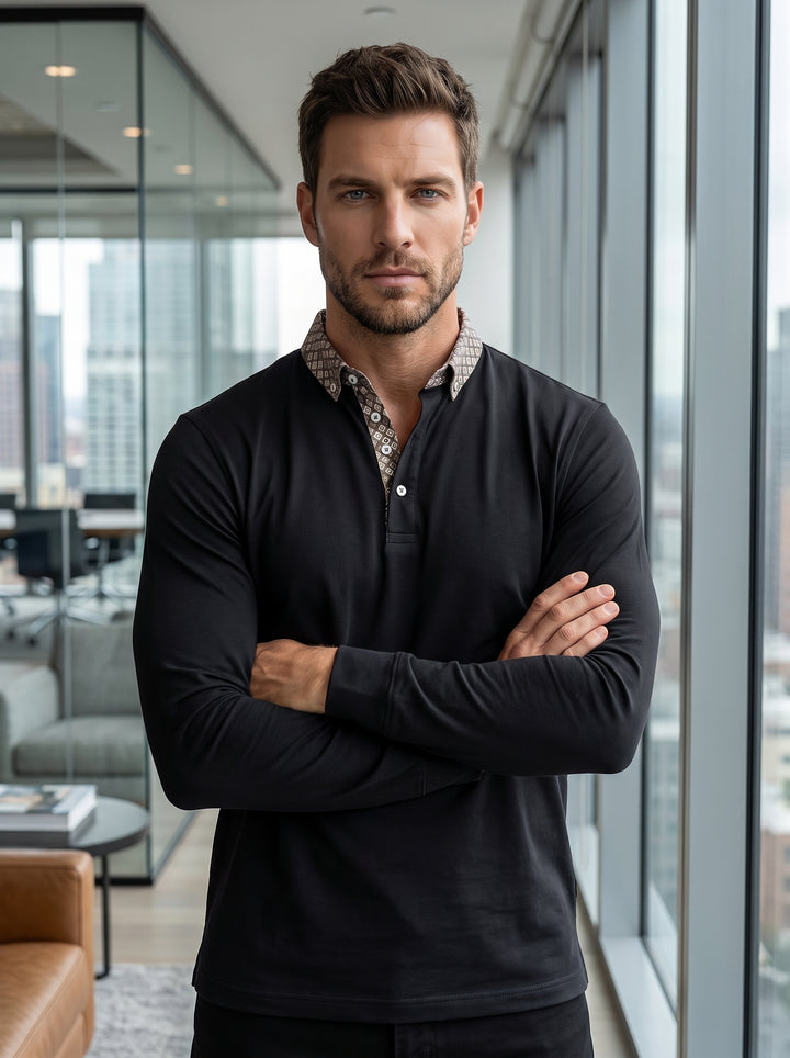 A sleek black long-sleeve polo shirt featuring a contrast geometric pattern on the inner collar and placket. It offers a modern slim fit with button details, blending casual comfort with sophisticated, detailed styling for a versatile wardrobe staple.