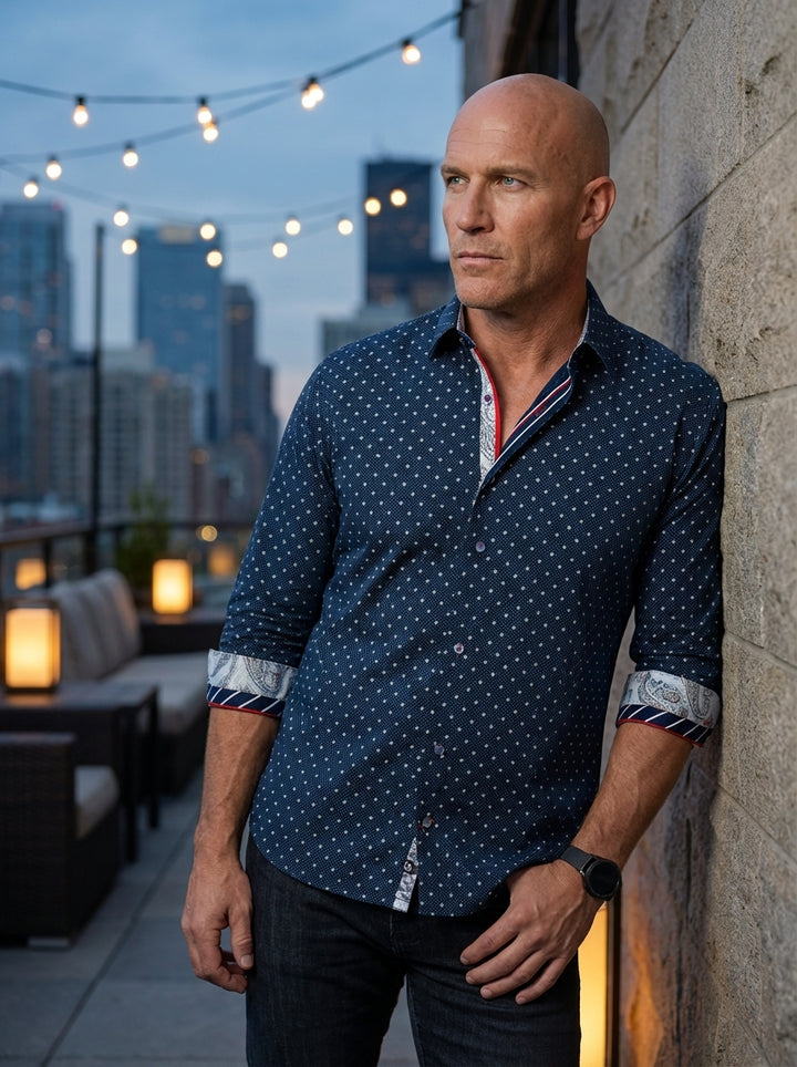 This sophisticated navy button-down features a subtle white micro-floral pattern, elevated by striking contrast details. The cuffs and placket showcase an intricate paisley print paired with nautical red, white, and blue stripes, offering a unique, tailor