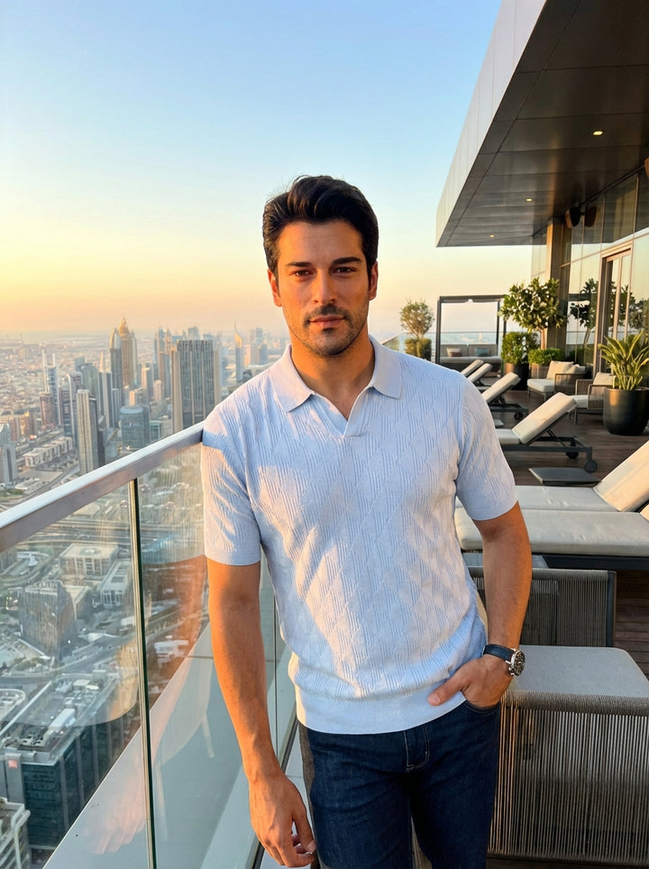 Elevate your casual wardrobe with this sophisticated light blue short-sleeved knit polo. Featuring a refined textured diamond pattern and a modern open collar design, it offers a tailored fit that seamlessly transitions from professional office environmen