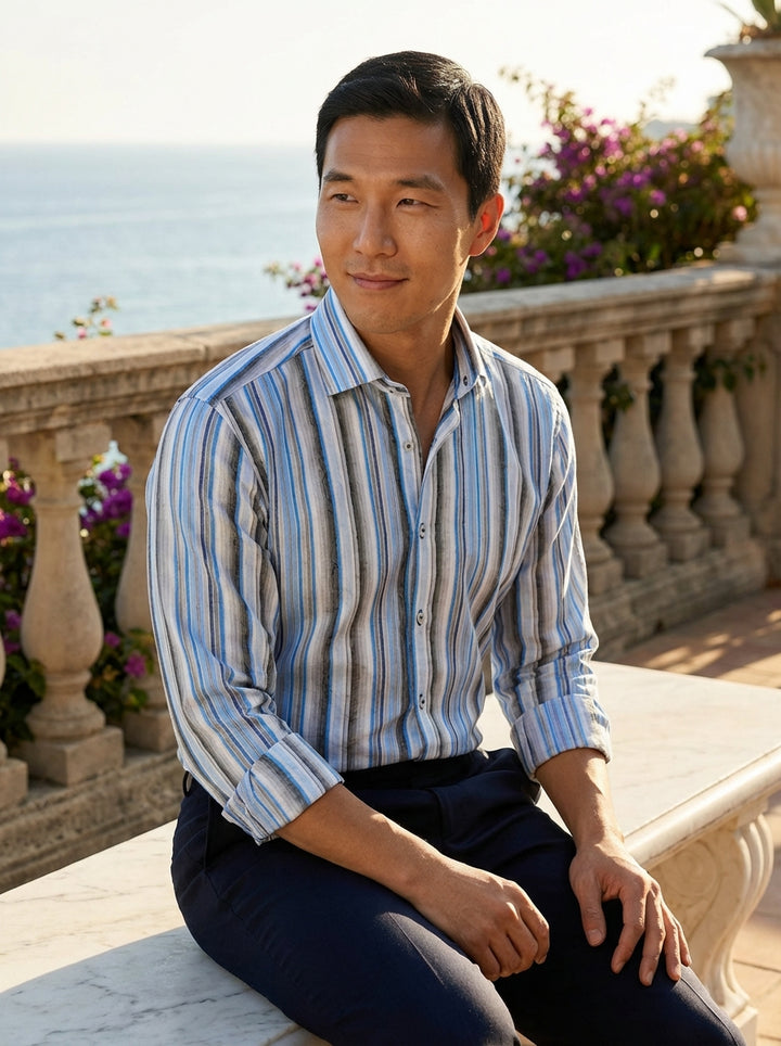 The Masutto premium striped dress shirt features a sophisticated palette of cerulean blue, cool grey, and crisp white. Crafted with a unique jacquard-woven overlay texture and contrasting button details, this shirt offers a modern take on classic tailored