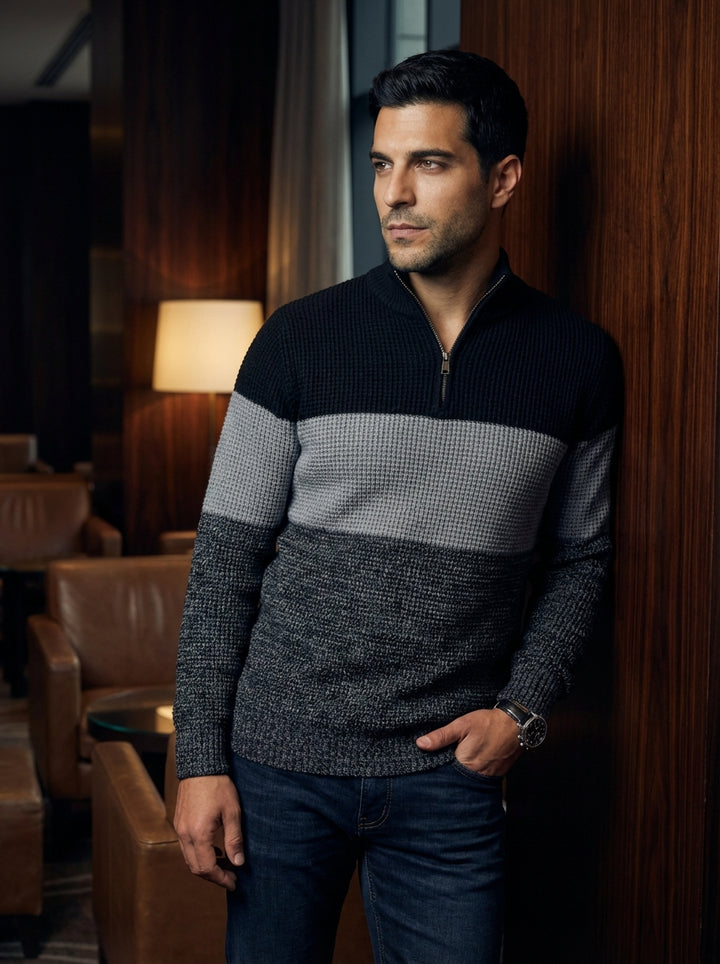 This sophisticated men's quarter-zip sweater features a modern tri-tone color-block design in black, heather grey, and charcoal. Crafted with a textured ribbed knit and a sleek metallic zipper, it offers a refined silhouette that seamlessly transitions fr
