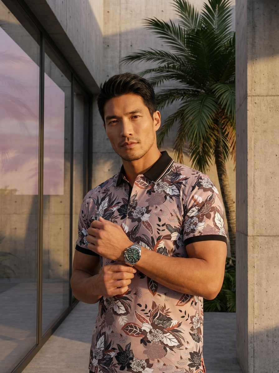 This men's short-sleeve polo shirt features a sophisticated floral print in muted tones of mauve, white, and charcoal. The design is elevated by a contrasting black collar and ribbed sleeve cuffs, offering a modern, tailored fit for smart-casual wardrobes