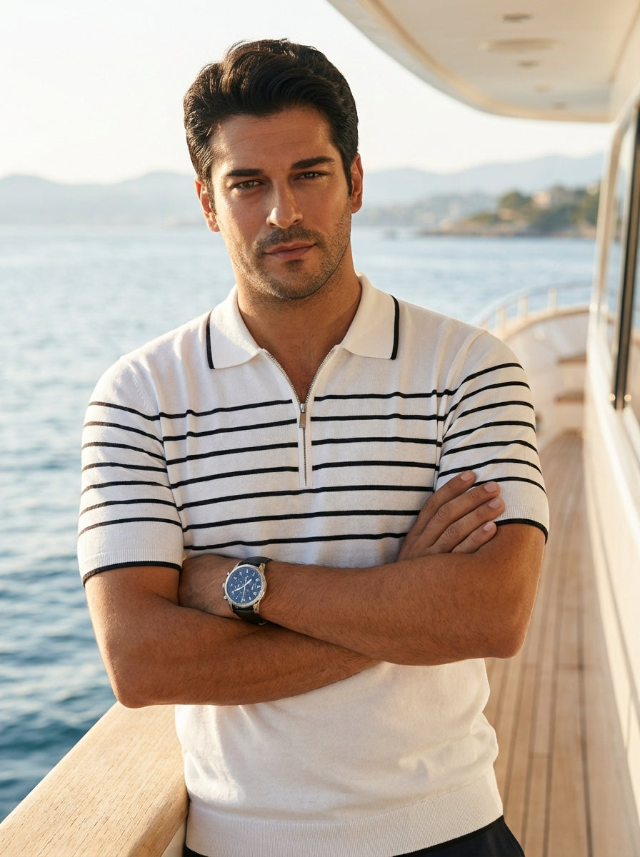 This premium white knit polo features a distinctive quarter-zip neckline and sharp black horizontal stripes across the chest and sleeves. Crafted for a tailored fit, the design includes contrasting trim on the collar and cuffs, blending athletic comfort w