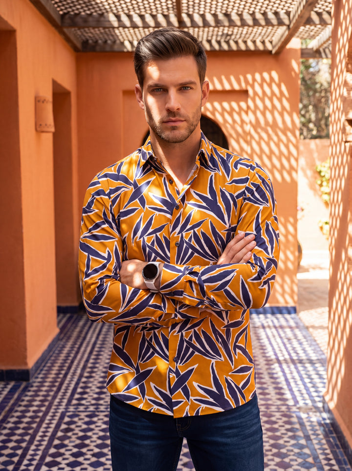 This striking long-sleeve button-down shirt features a vibrant mustard yellow base accented by a bold navy and white abstract botanical print. Crafted for a tailored fit, it offers a contemporary silhouette perfect for making a stylish, confident fashion 