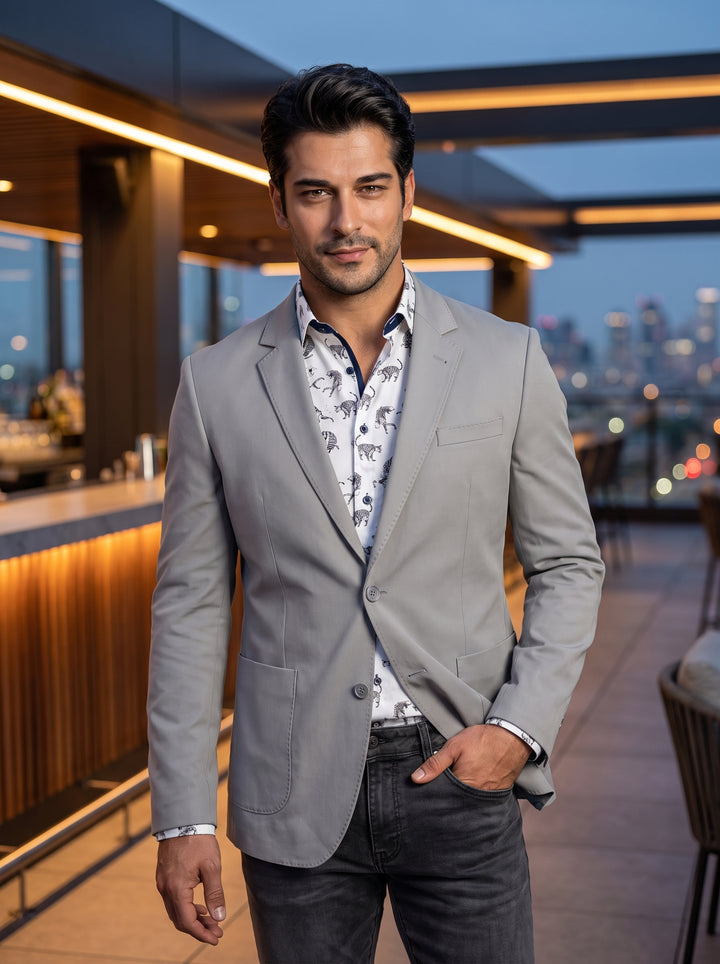 This light grey, slim-fit blazer features a notched lapel and two-button closure, paired with a white button-down shirt showcasing an intricate black leopard print. The tailored design includes patch pockets and clean lines for a sophisticated yet contemp