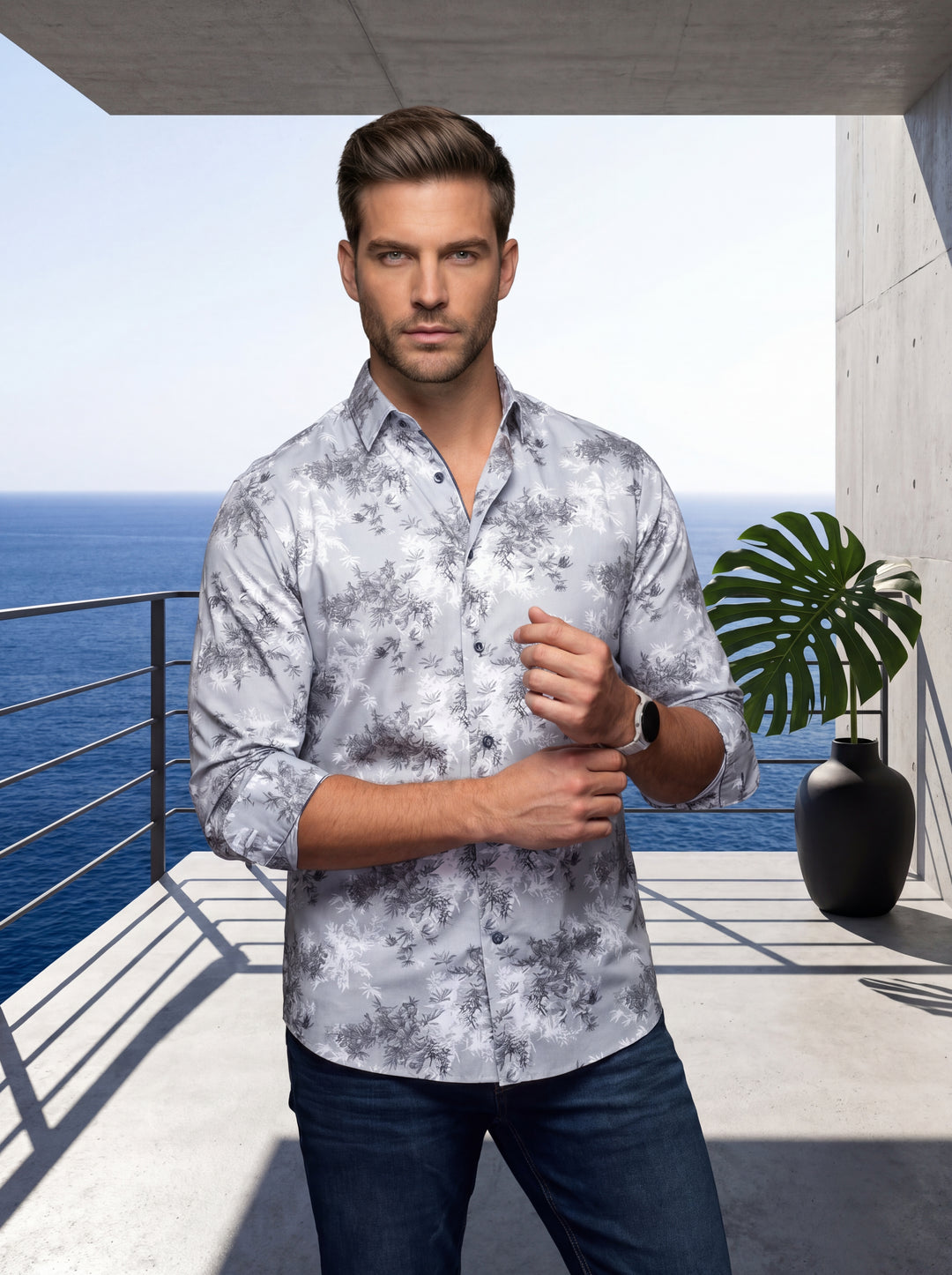 This stylish men's button-down shirt features a sophisticated grey and white floral-inspired motif on a high-quality fabric. Its tailored fit is complemented by dark contrast buttons and a crisp collar, making it a versatile piece for contemporary masculi