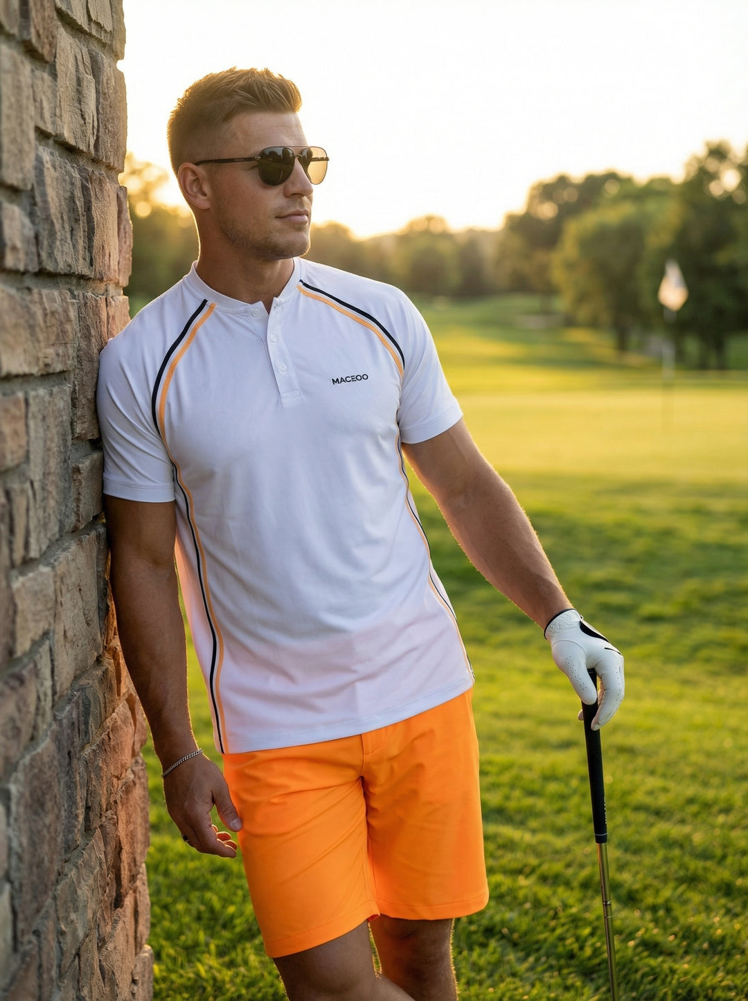 A modern athletic polo featuring a clean white base with high-contrast black and orange piped detailing along the raglan sleeves and side seams. The moisture-wicking fabric and mandarin collar offer a contemporary look, paired here with vibrant orange per