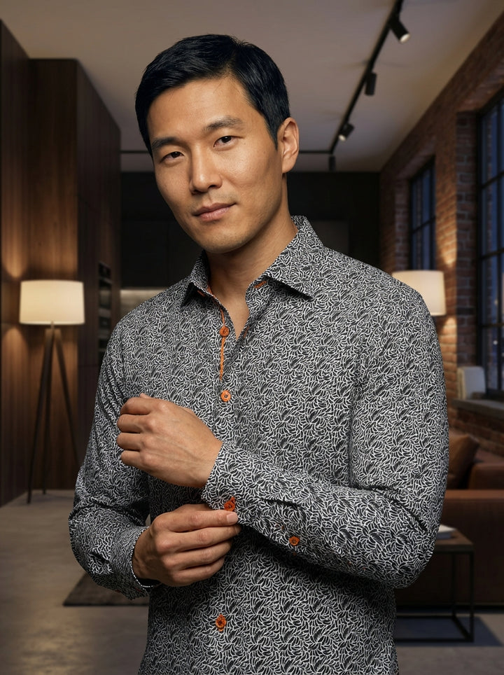 This Masutto button-down shirt features a sophisticated black and white swirling petal print. Accented with contrasting orange stitching and amber-toned buttons, the high-quality fabric offers a modern fit suitable for both professional settings and styli
