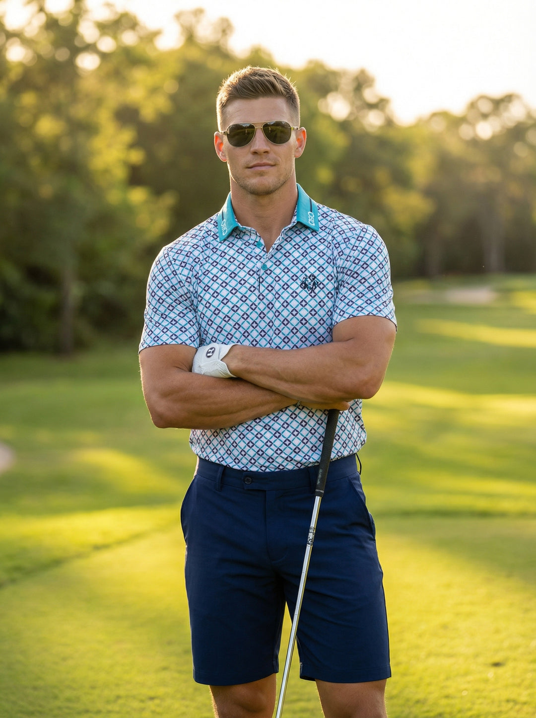 This stylish short-sleeve polo features a vibrant geometric diamond print in shades of blue and teal. Designed with a contrast teal collar and a modern athletic fit, it offers a sophisticated look for active or leisure activities in the sun.