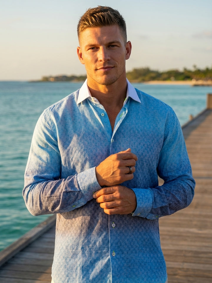 This premium long-sleeved button-down shirt features a sophisticated blue-to-navy ombre gradient with an intricate micro-pattern texture throughout. Its contrasting white pointed collar and refined linen-blend fabric offer a breathable, elevated look perf