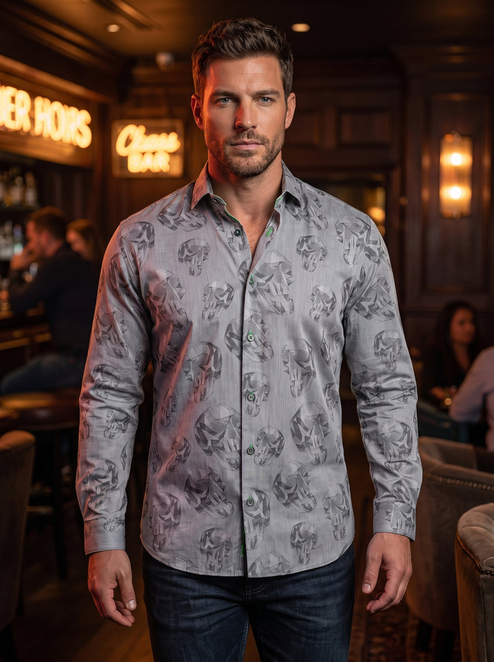 This grey button-down shirt features an all-over geometric skull print for a modern, edgy aesthetic. Crafted with a tailored fit, it includes subtle neon green stitching details on the buttonholes and inner collar, paired with classic dark grey buttons.