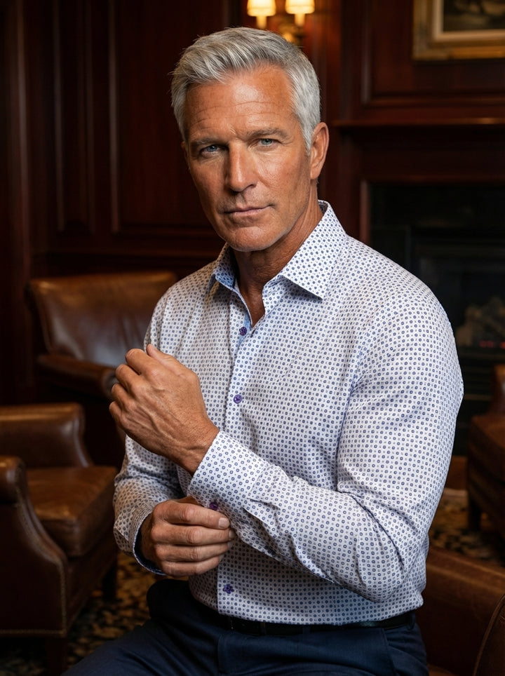 This men's long-sleeve dress shirt features a crisp white base with a sophisticated blue geometric diamond pattern. It is designed with a modern tailored fit, contrasting navy blue interior collar details, and purple buttons for a unique, polished aesthet