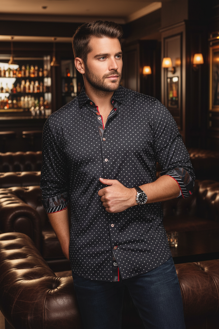 This sophisticated men's button-down shirt features a dark base with subtle polka dots, accented by a contrasting red lining and unique cuff details. Perfect for a refined, modern look.