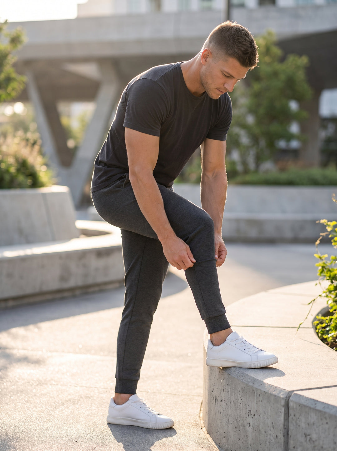 These charcoal grey tailored joggers feature a slim-fit silhouette, an elasticated drawstring waistband, and subtle ribbing. Designed with high-quality performance fabric, they provide exceptional comfort and durability, making them an essential staple fo