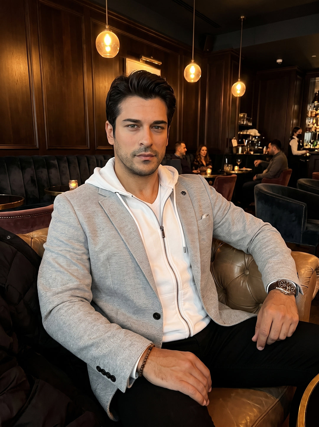 This light grey textured blazer features a tailored fit and notch lapels, layered over an integrated white zip-up hoodie. A versatile hybrid design, it combines smart tailoring with casual athleisure details for a modern, sophisticated urban look.