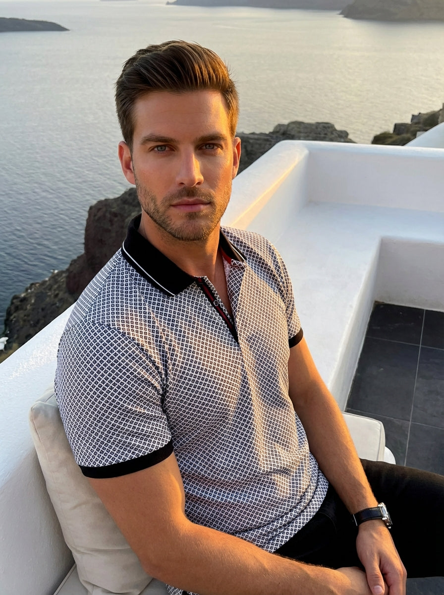 This stylish men's polo features an intricate black and white geometric diamond pattern. It is designed with a contrasting black ribbed collar featuring a white tipping edge, black sleeve cuffs, and a unique button placket with subtle red accents.