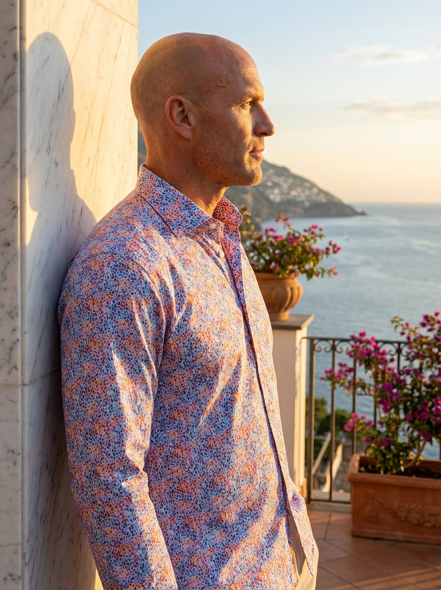This Masutto long-sleeved button-down shirt features a vibrant, multi-colored micro-print pattern composed of oval-shaped dots in shades of blue, orange, red, and purple. It includes a classic spread collar, orange interior piping, and elegant white butto