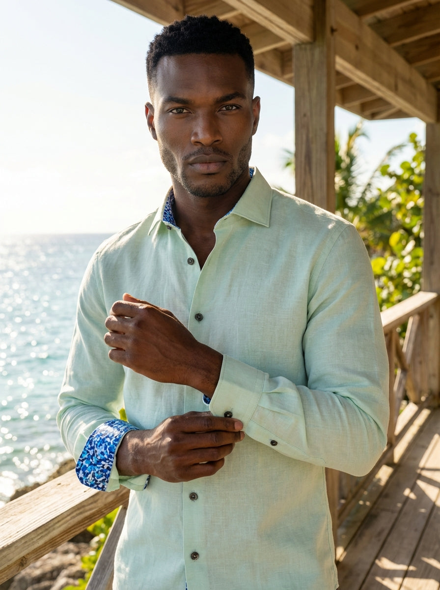 This Masutto long-sleeve button-down shirt features a refreshing pale mint green hue with a refined linen-like texture. It is detailed with dark contrast buttons and a vibrant blue mosaic-patterned lining inside the collar and cuffs for a sophisticated to