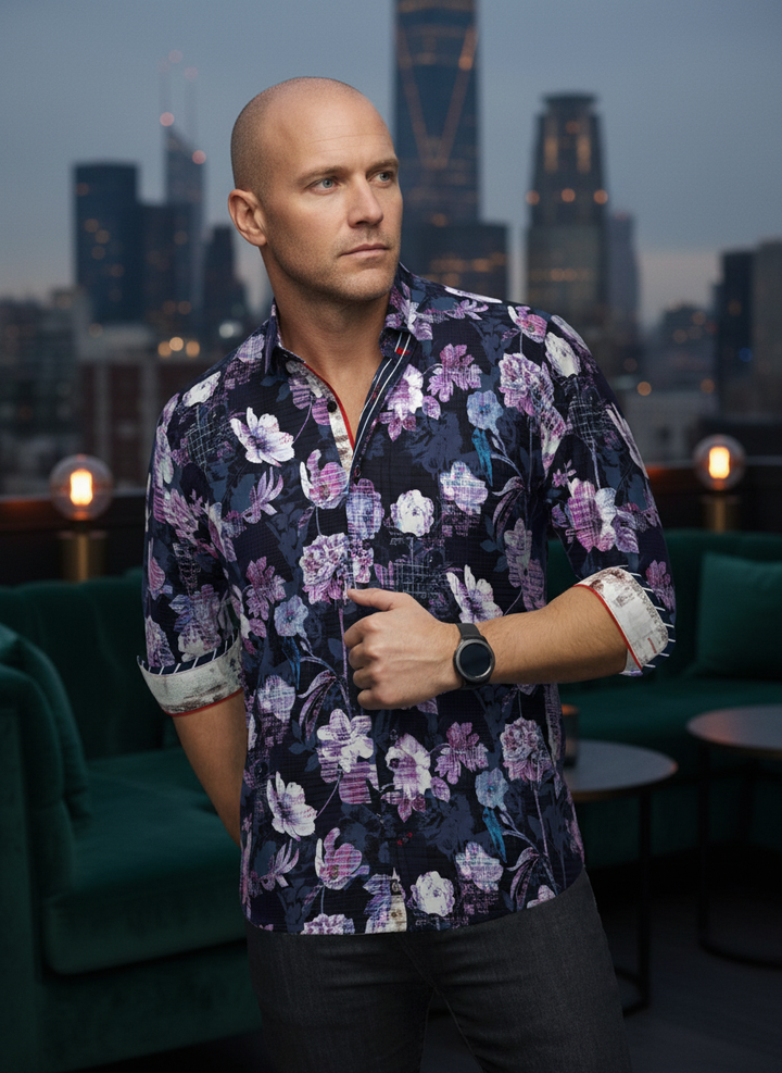 An elegant navy button-down featuring a bold, artistic floral print in shades of violet and teal. Meticulously detailed with contrasting red trim and patterned linings, this piece blends contemporary flair with refined, tailored craftsmanship for a stando