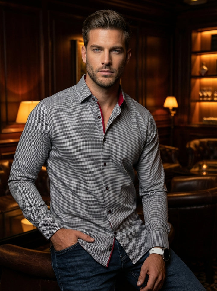 This premium long-sleeve button-down shirt features a sophisticated micro-check pattern in monochrome tones. Accented with a vibrant red inner collar lining and contrasting dark buttons, it offers a refined slim fit that seamlessly transitions from profes