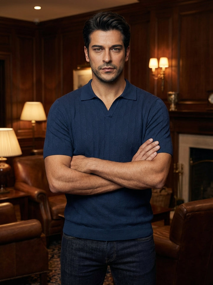 A sophisticated navy blue knit polo featuring a subtle textured pattern and a sleek, buttonless open collar. This short-sleeved garment offers a modern tailored fit, blending casual comfort with refined masculine elegance, perfect for versatile styling wi