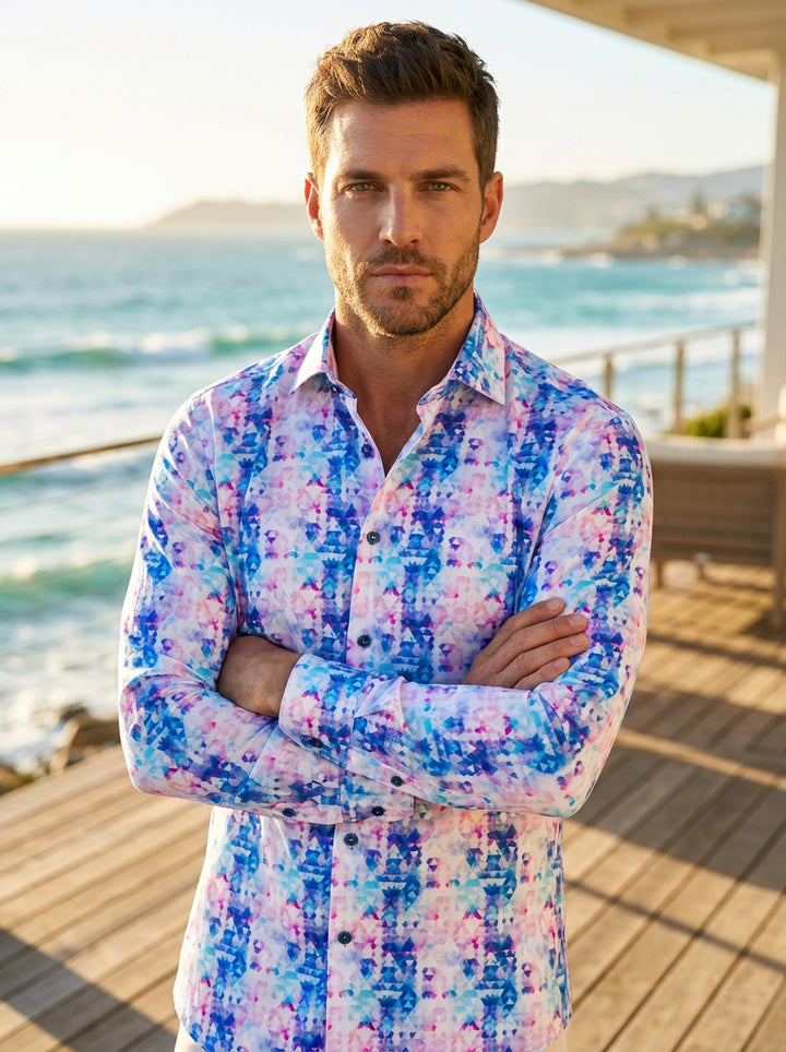 This Masutto long-sleeved button-down shirt features a vibrant geometric mosaic print in shades of blue, pink, and purple. Made from a crisp white fabric, it includes a spread collar, contrasting dark buttons, and a tailored fit for contemporary style.