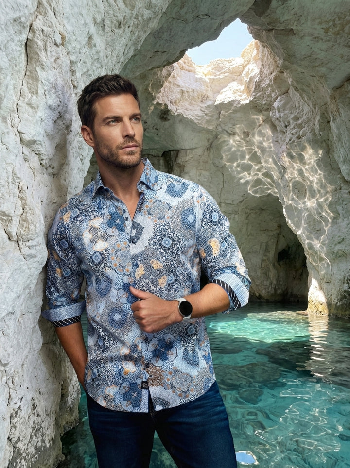 This premium long-sleeved button-down shirt features an intricate mosaic and floral print in shades of blue, white, and amber. It includes unique contrasting cuff lining and a tailored fit, making it a sophisticated choice for modern, stylish men's casual