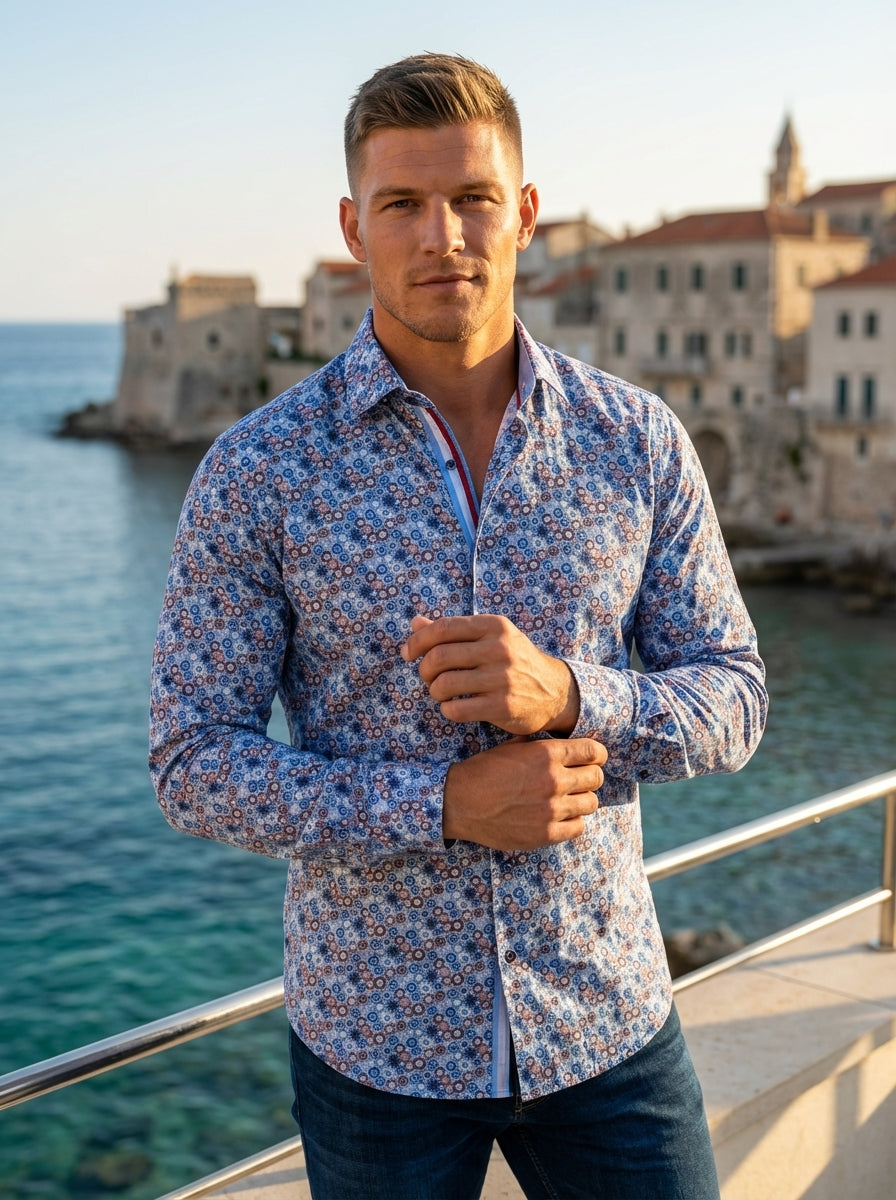 This men's long-sleeve button-down shirt features an intricate, all-over geometric mosaic print in shades of blue, white, and red. Crafted with a tailored fit, it includes a contrasting inner collar and placket detail for a sophisticated, modern aesthetic