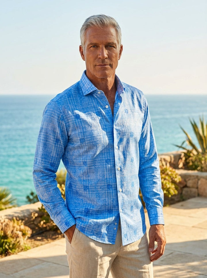 This Masutto long-sleeved button-down shirt features a vibrant cerulean blue color with an intricate layered pattern. The design combines a classic windowpane check with tonal floral jacquard motifs, accented by white pearlescent buttons for a sophisticat