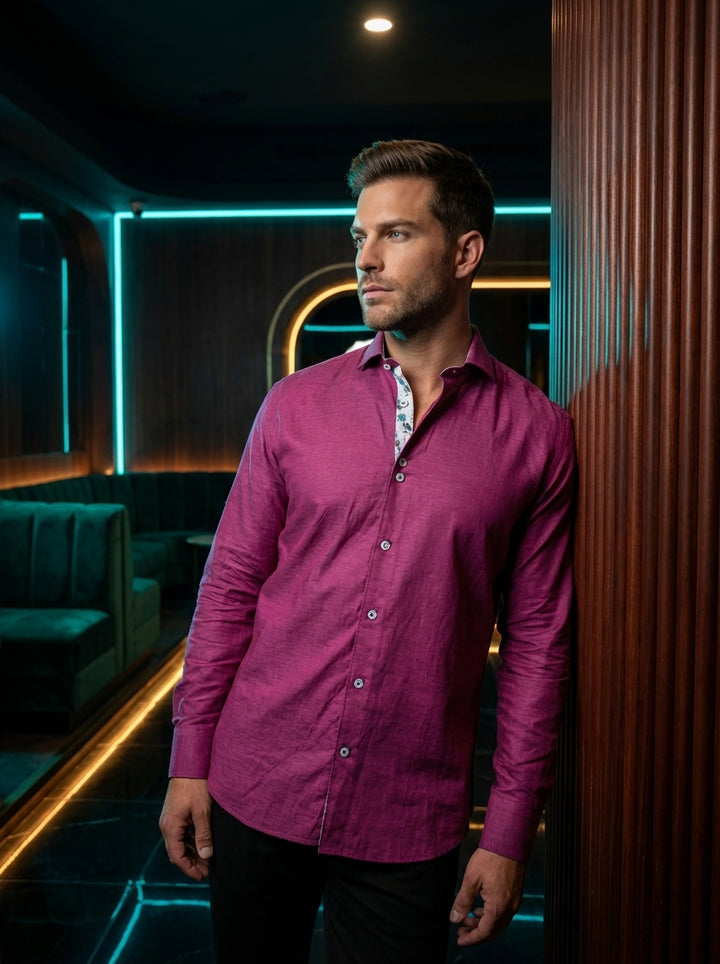 This vibrant magenta long-sleeve shirt features a rich slub texture and a tailored fit. The interior collar is accented with a playful palm tree print, while unique double-button details and contrasting stitching on the buttons add a modern, sophisticated