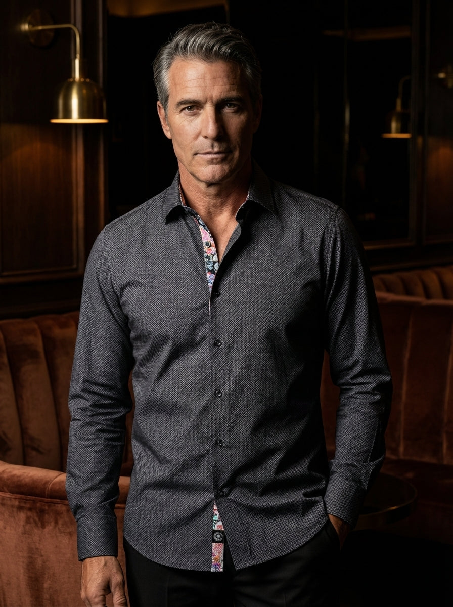 This sophisticated charcoal button-down shirt features a fine geometric micro-print and contrasting floral inner placket details. Designed with a modern slim fit and long sleeves, it offers a refined aesthetic that seamlessly blends classic tailoring with