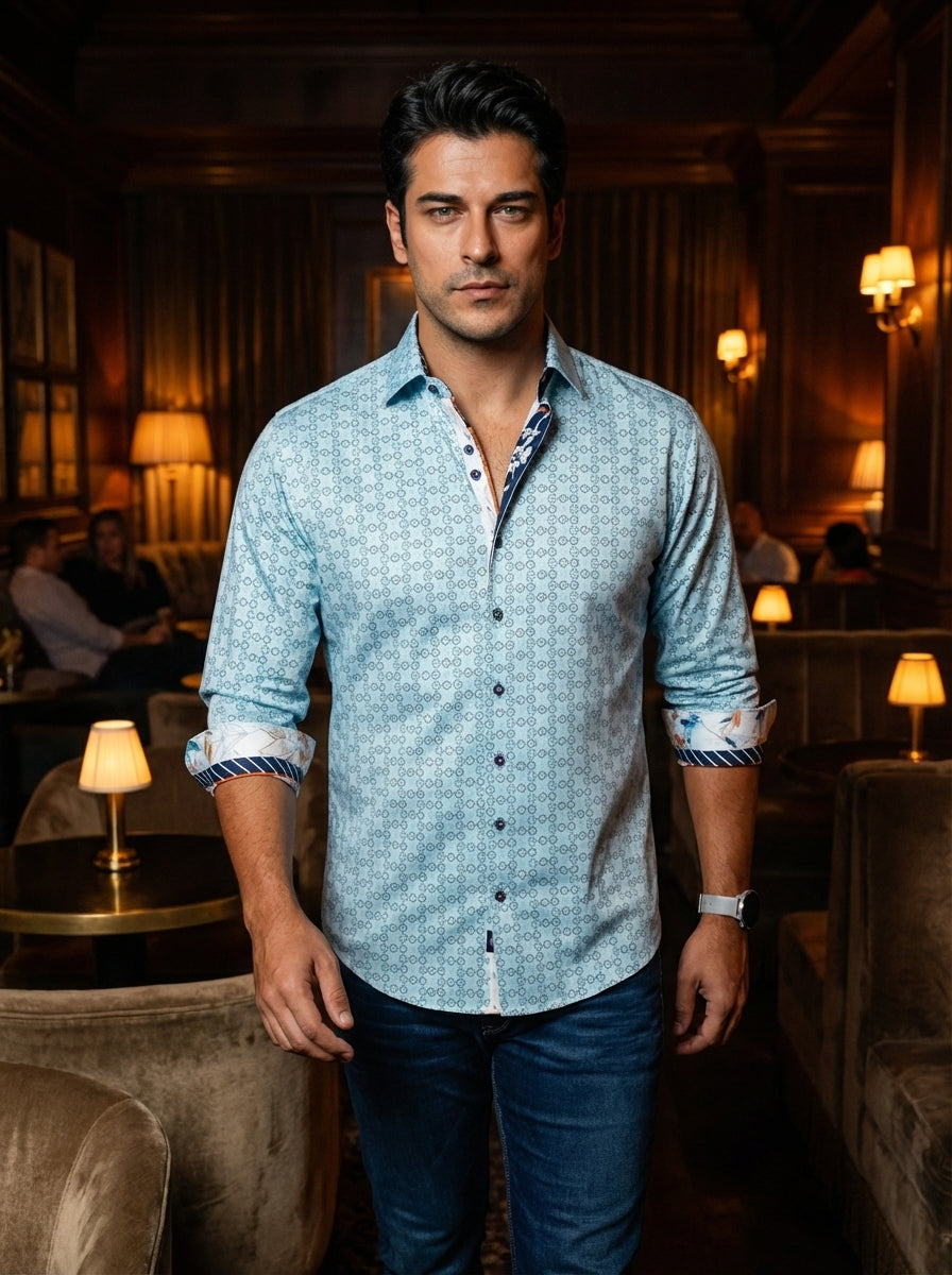 This light blue long-sleeve button-down shirt features a meticulous geometric pattern with contrasting navy and white floral accents on the inner collar and cuffs. Tailored for a modern fit, it includes a spread collar and distinct navy-bordered buttons f