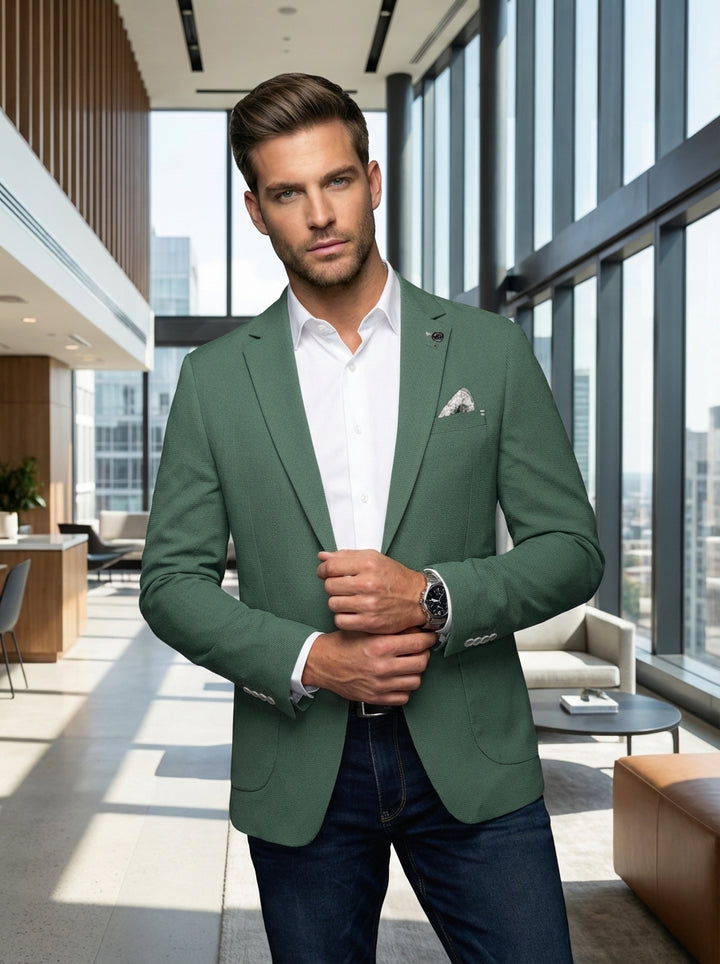 A sophisticated men's sage green textured blazer featuring a tailored fit, notch lapel, and a distinctive patterned pocket square. Paired with a crisp white button-down shirt and dark denim, this ensemble offers a perfect balance of elegance and casual st