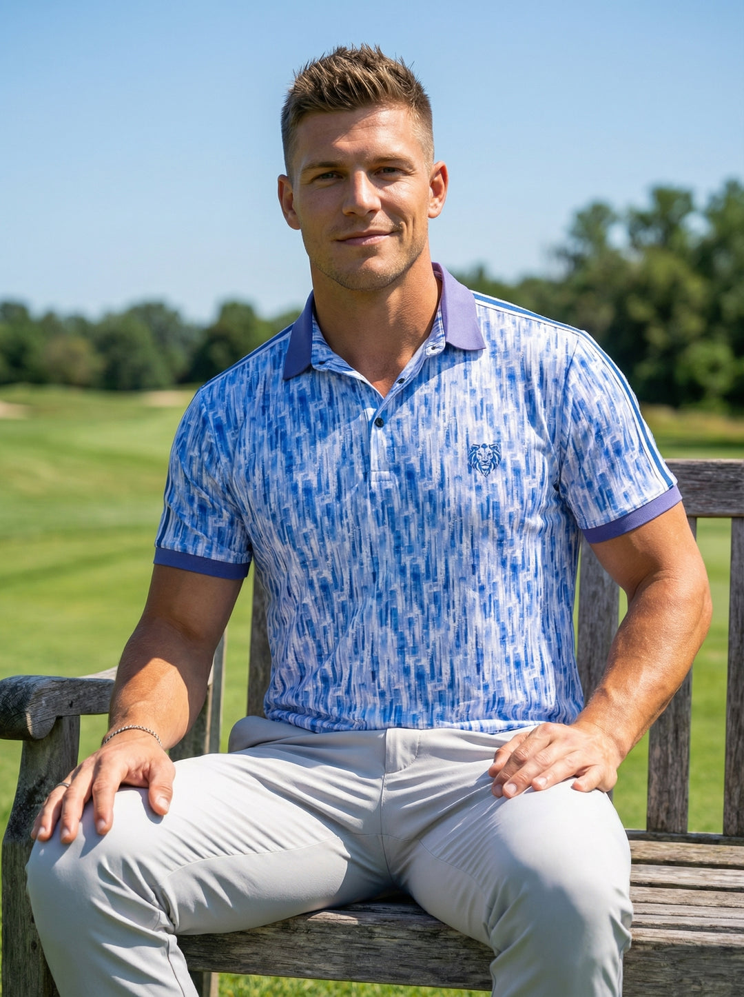This men's performance polo features a vibrant blue and white abstract vertical brushstroke pattern. It is designed with a solid purple contrast collar and sleeve cuffs, side-seam racing stripes, and a signature lion logo on the chest for athletic style.