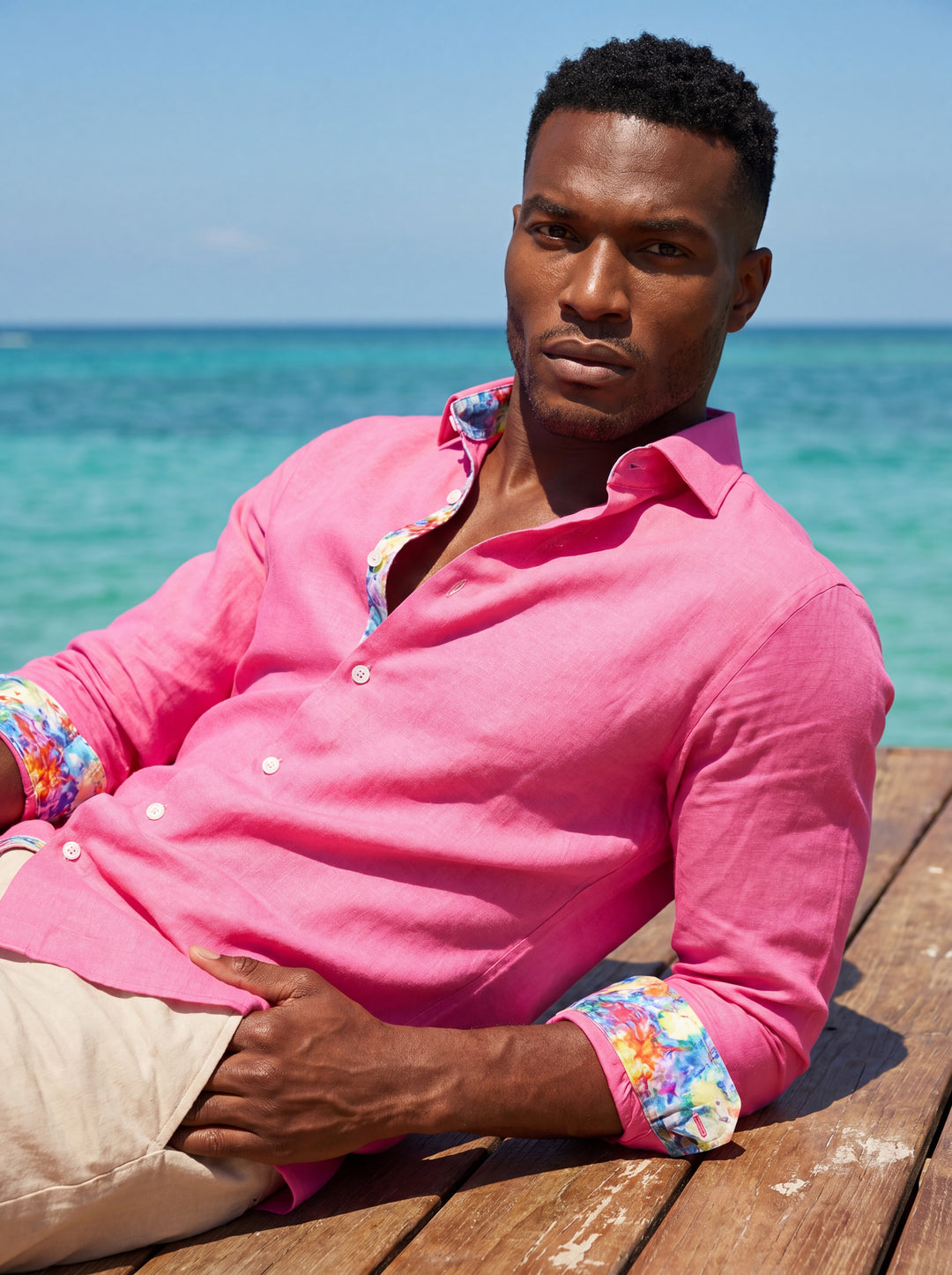 This vibrant Masutto button-down shirt is crafted from high-quality hot pink linen, featuring a refined spread collar and a tailored fit. The inner collar and cuffs are lined with a playful, colorful floral pattern that adds a unique touch.