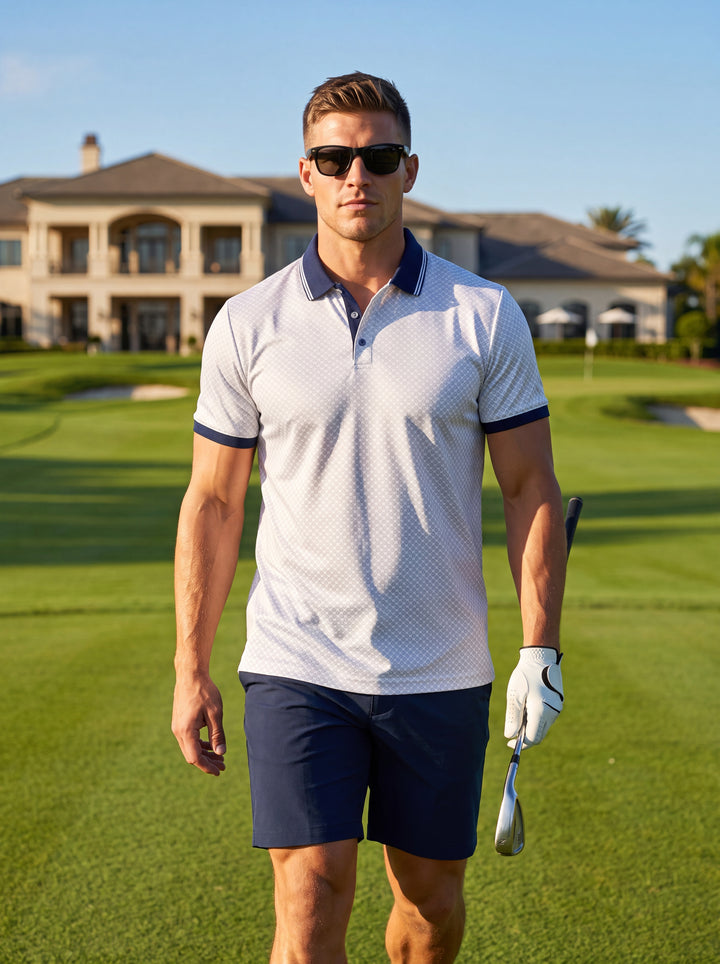 This premium white polo shirt features a sophisticated geometric diamond pattern. It is detailed with a contrasting navy blue ribbed collar and sleeve cuffs, complete with a classic three-button placket. The tailored fit offers a modern, sharp silhouette 