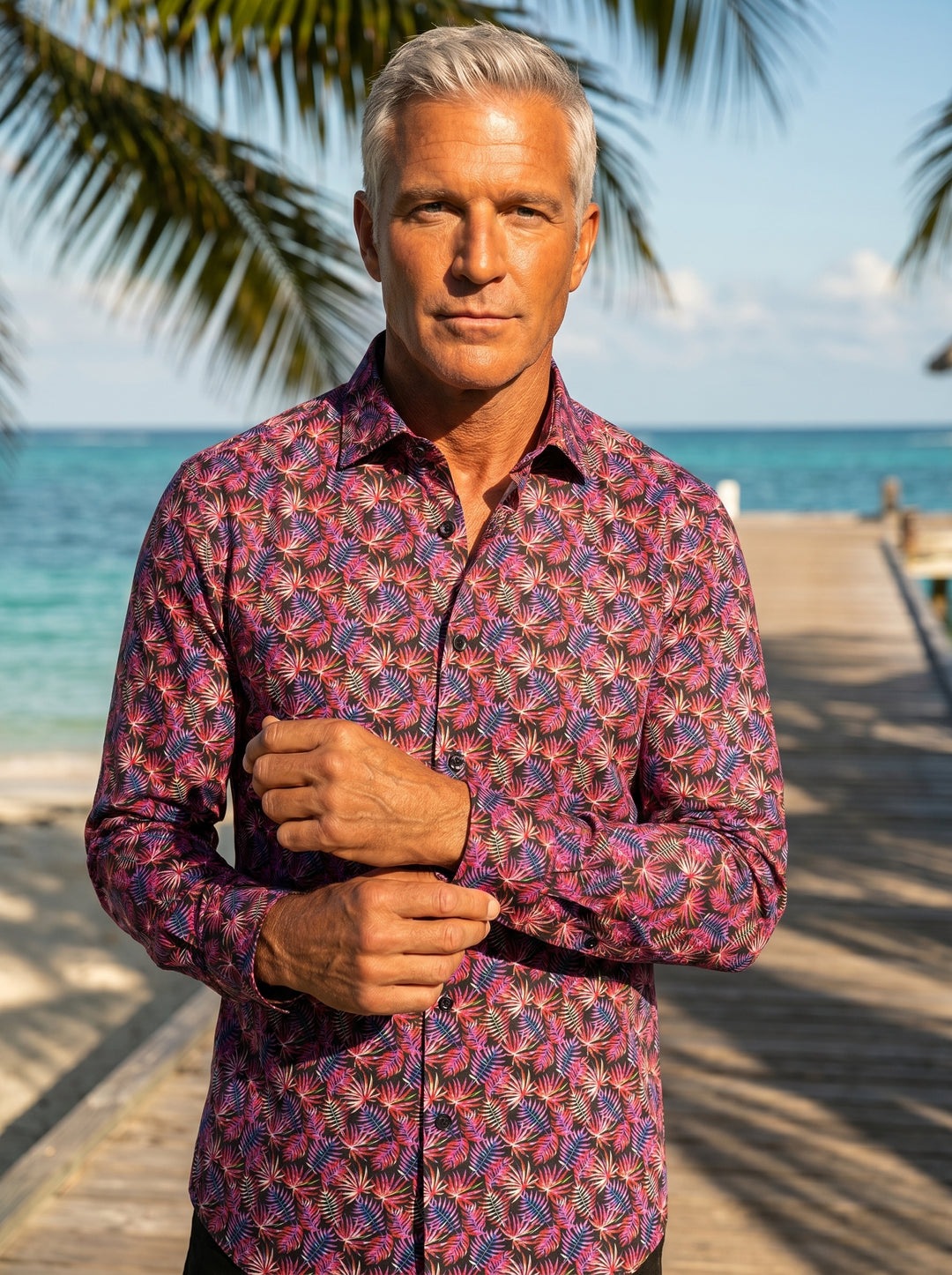 This Masutto button-down shirt features a vibrant tropical fern print with pink, purple, and orange hues on a black base. Crafted with a classic collar and long sleeves, it offers a sophisticated take on bold, exotic patterns for modern style.