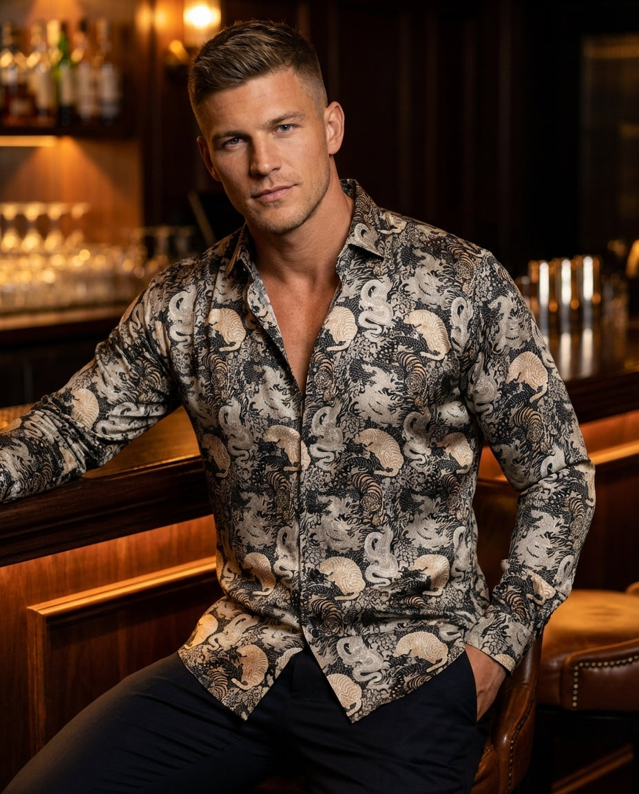 This men's long-sleeve button-down shirt features an intricate oriental-inspired print with detailed tiger and dragon motifs. Crafted from a smooth, lightweight fabric in shades of black, cream, and tan, it offers a sophisticated look for modern evening a