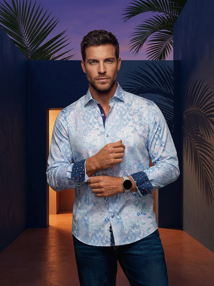 This sophisticated men's long-sleeve button-down features an intricate pastel paisley print with subtle floral accents. Crafted for a tailored fit, it includes a contrasting navy patterned collar lining and cuffs, perfect for elevating a modern smart-casu