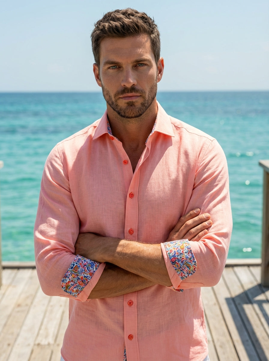 This Masutto long-sleeved button-down shirt features a vibrant salmon pink linen-blend fabric with a structured spread collar. The interior cuffs and collar are lined with a colorful floral paisley print, complemented by tonal coral buttons for a sophisti