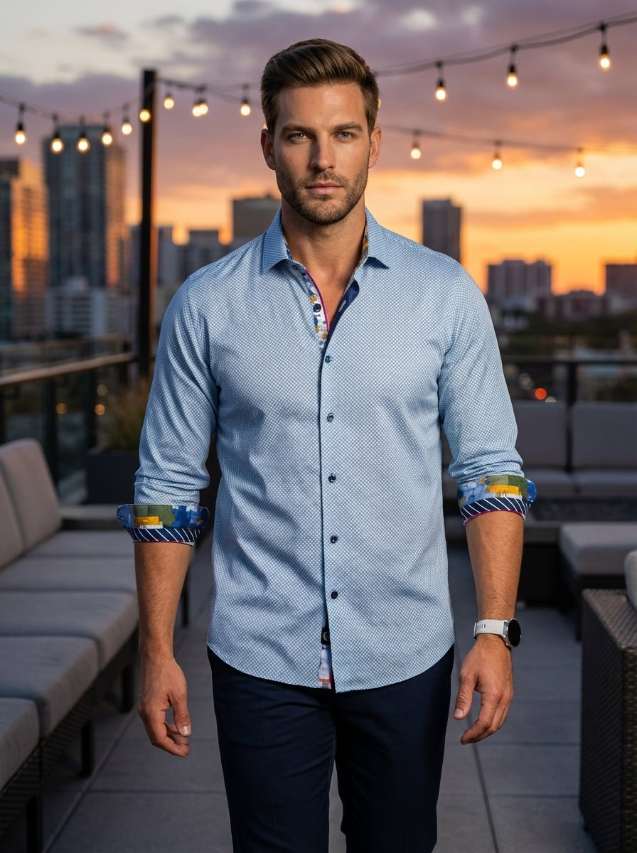 A sophisticated light blue button-down dress shirt featuring an intricate geometric micro-pattern. The design is elevated by vibrant, multi-colored artistic prints on the inner collar and cuffs, adding a bold contemporary twist to a classic, tailored fit 