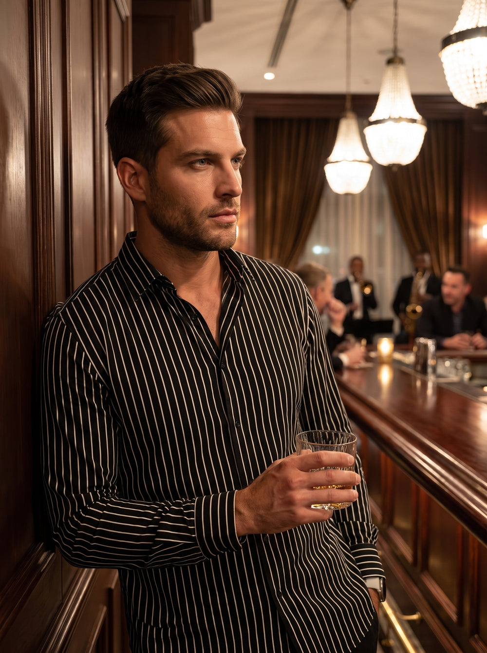 This men's long-sleeve button-down shirt features a sophisticated black and white vertical pinstripe pattern. Designed with a classic collar and a tailored fit, the garment offers a sharp, modern aesthetic suitable for evening wear or high-end social gath
