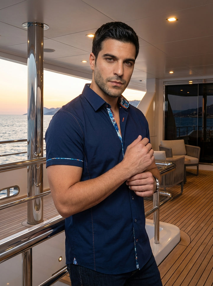 Elevate your casual wardrobe with this navy blue short-sleeve button-down shirt. Featuring a tailored fit, it boasts vibrant patterned trim on the inner collar and sleeve hems. The contrasting orange stitching adds a subtle, modern touch to this sophistic