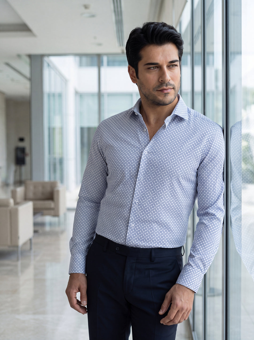 This light blue long-sleeve dress shirt features a sophisticated all-over geometric print with navy accents. Crafted with a tailored fit, it includes a spread collar and adjustable cuffs, making it a versatile piece for sharp, modern business casual attir