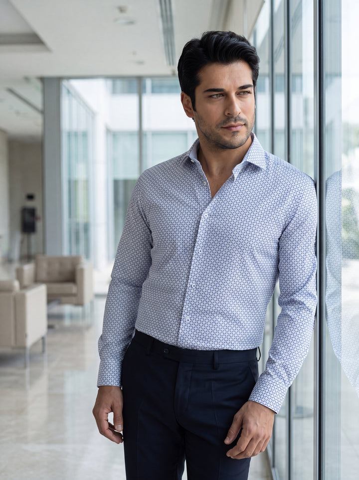 This light blue long-sleeve dress shirt features a sophisticated all-over geometric print with navy accents. Crafted with a tailored fit, it includes a spread collar and adjustable cuffs, making it a versatile piece for sharp, modern business casual attir