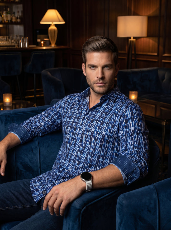 This premium long-sleeved button-down shirt features a striking blue and white abstract geometric pattern with a subtle gradient effect. Crafted from high-quality fabric, it includes contrasting micro-dot inner cuffs and a sophisticated spread collar, per